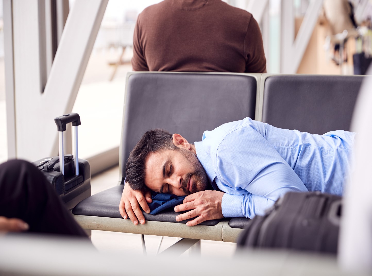 businessman-sleeping-on-seats-in-airport-T328QU4